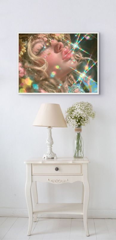 The rainbow sparkle girl print hung on a pale wall above a white nightstand with a small lamp and a glass jar of flowers.