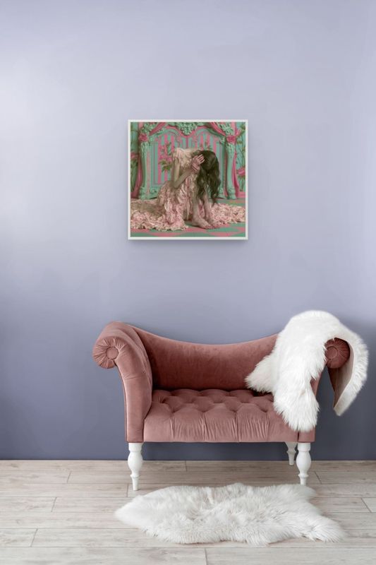The melting pink dress print hung on a grey wall above a blush velvet chaise with a white fur throw.