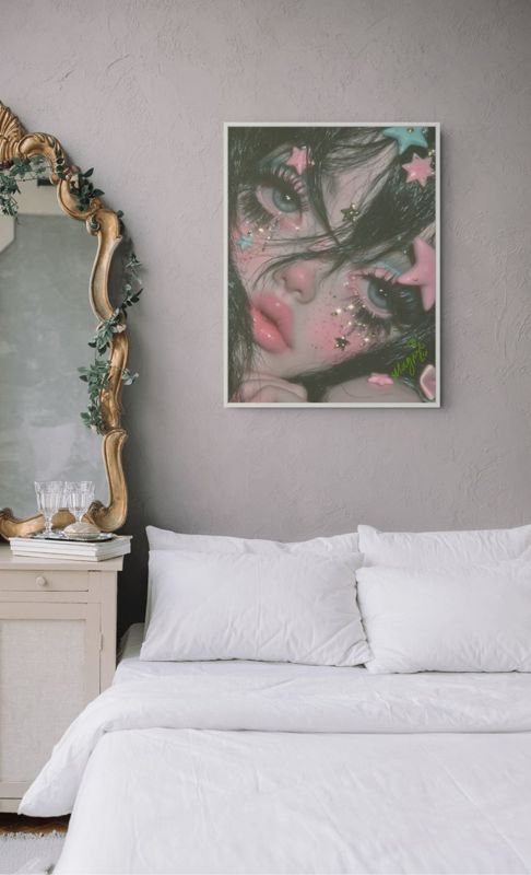 The star face print hung above a white bed beside an ornate gold mirror in a pale bedroom.