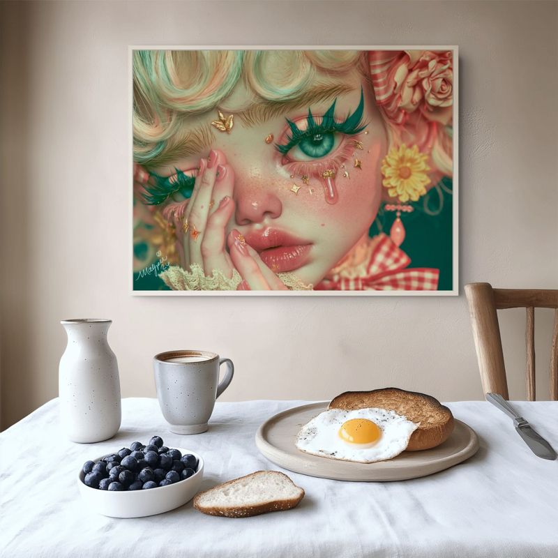 The crying clown doll print hung on a white wall above a breakfast table with a mug, a jug and a plate of eggs and bread.