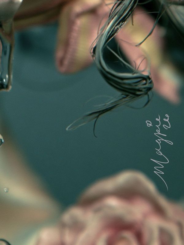 Close up of the lower right corner: a wet dark curl against deep teal with the small white Magpie signature written vertically.
