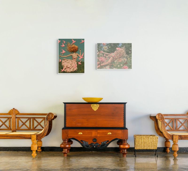 Both I Want to Be Disappointed prints hung together on a white wall above a carved wooden chest between two wooden benches.
