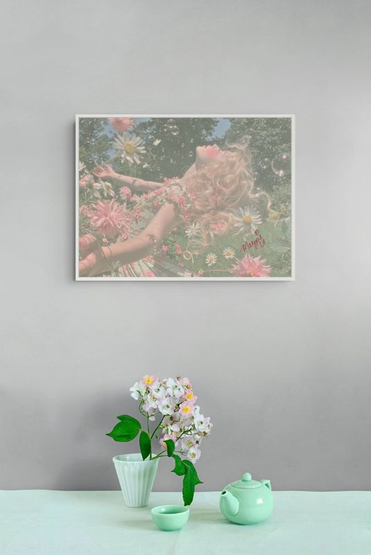 The girl in daisies print hung on a grey wall above a white surface with a mint vase of flowers and a teapot.