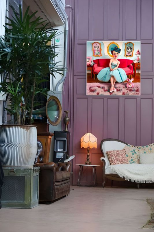 The woman on the pink couch canvas hung on a mauve paneled wall in a plant filled room with a leather armchair and a small lamp.