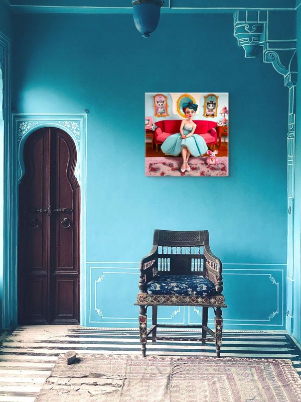The woman on the pink couch canvas hung on a bright teal wall beside an arched wooden door, above a carved chair.