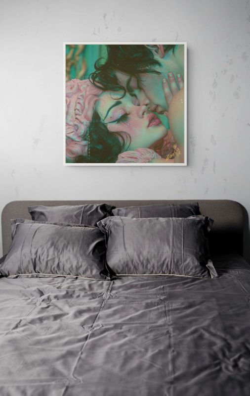 The lovers kiss print hung on a white brick wall above a bed with grey linen in a pale bedroom.