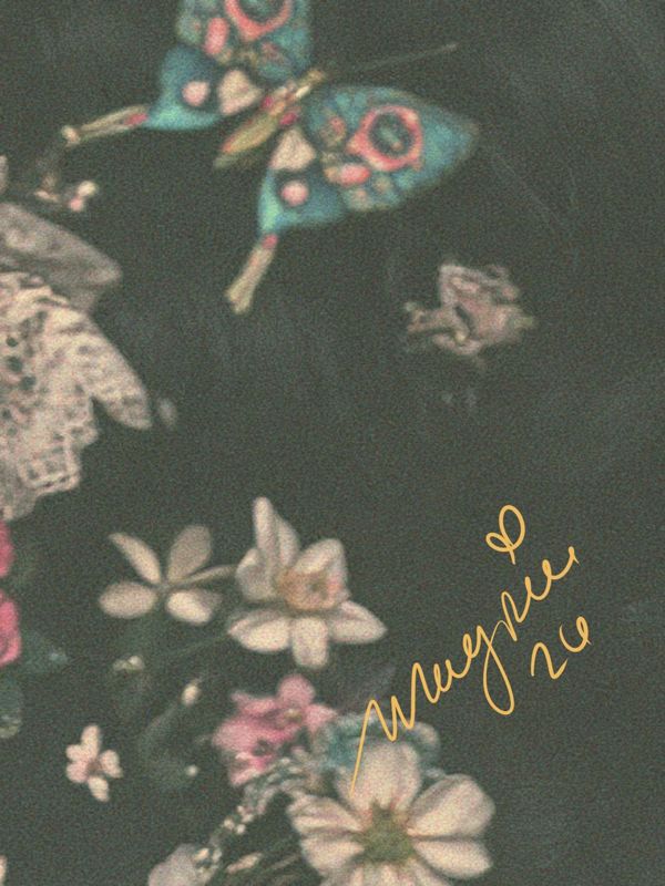 Close up of the lower right corner: scattered cream and pink flowers on a dark ground with the Magpie signature in gold script.