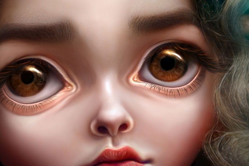 Close up detail of two warm amber eyes with soft lashes and worried brows on smooth porcelain skin.