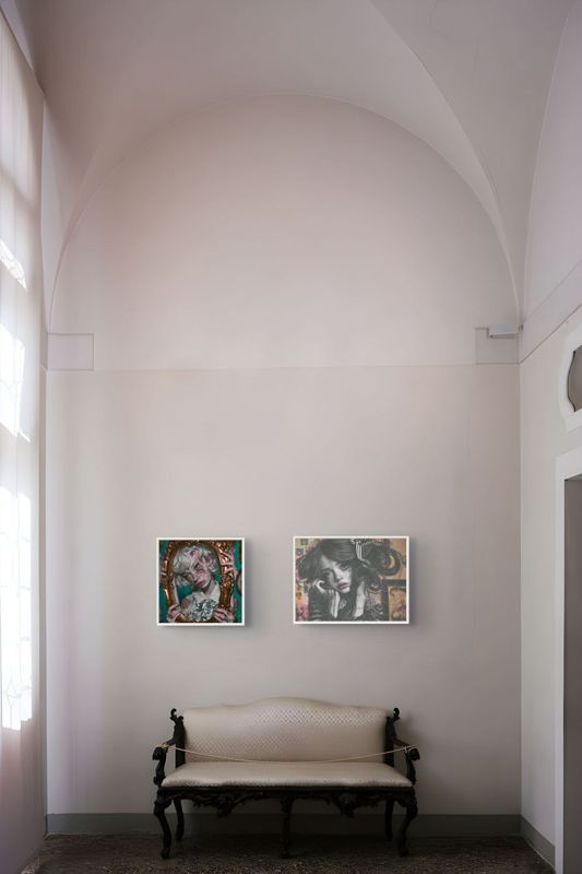Both What Do You Call It prints hung side by side in a tall pale arched room above a cream antique settee.