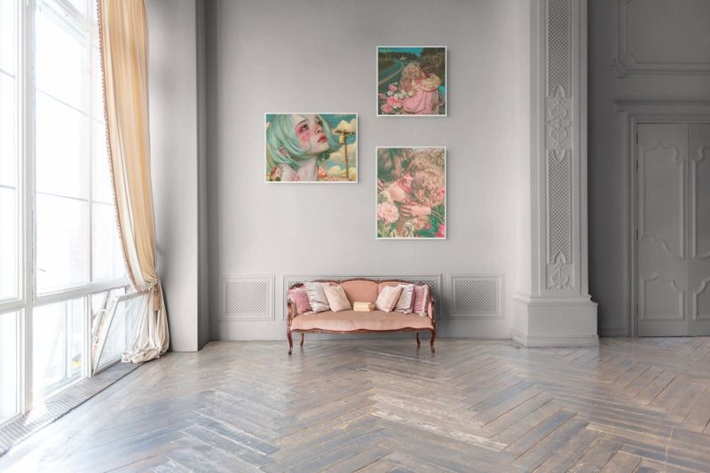 Three What's It Like to Have a Friend prints hung together on a grey wall above a small pink bench in a bright room.